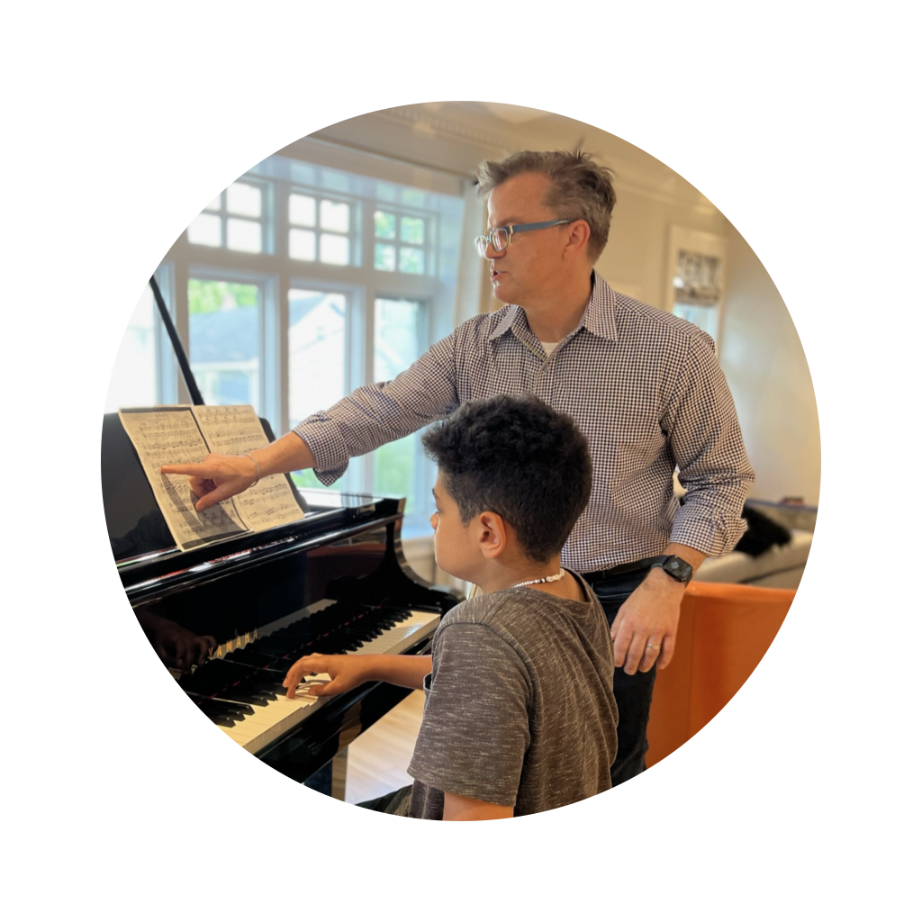 Gene Kelly instructing a student, pointing to the sheet music Gene Kelly instructing a student, pointing to the sheet music