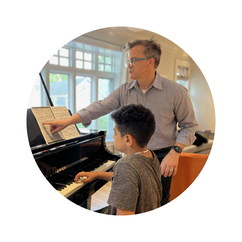 Gene Kelly instructing a student, pointing to the sheet music Gene Kelly instructing a student, pointing to the sheet music