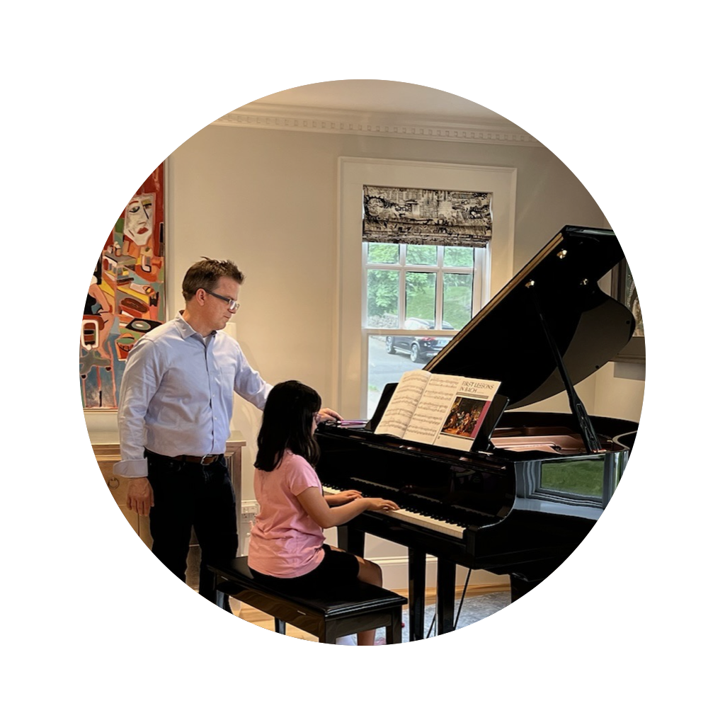 Gene Kelly working with a student sitting at the piano